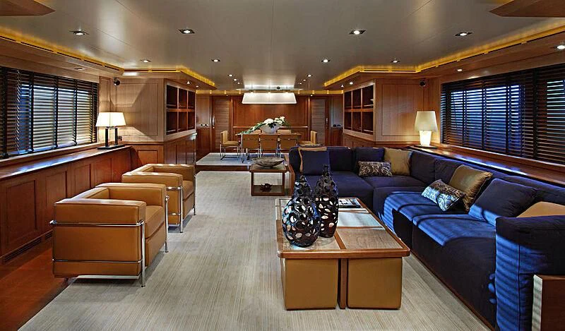 a living room with a blue couch and a coffee table aboard LADY I Yacht for Charter