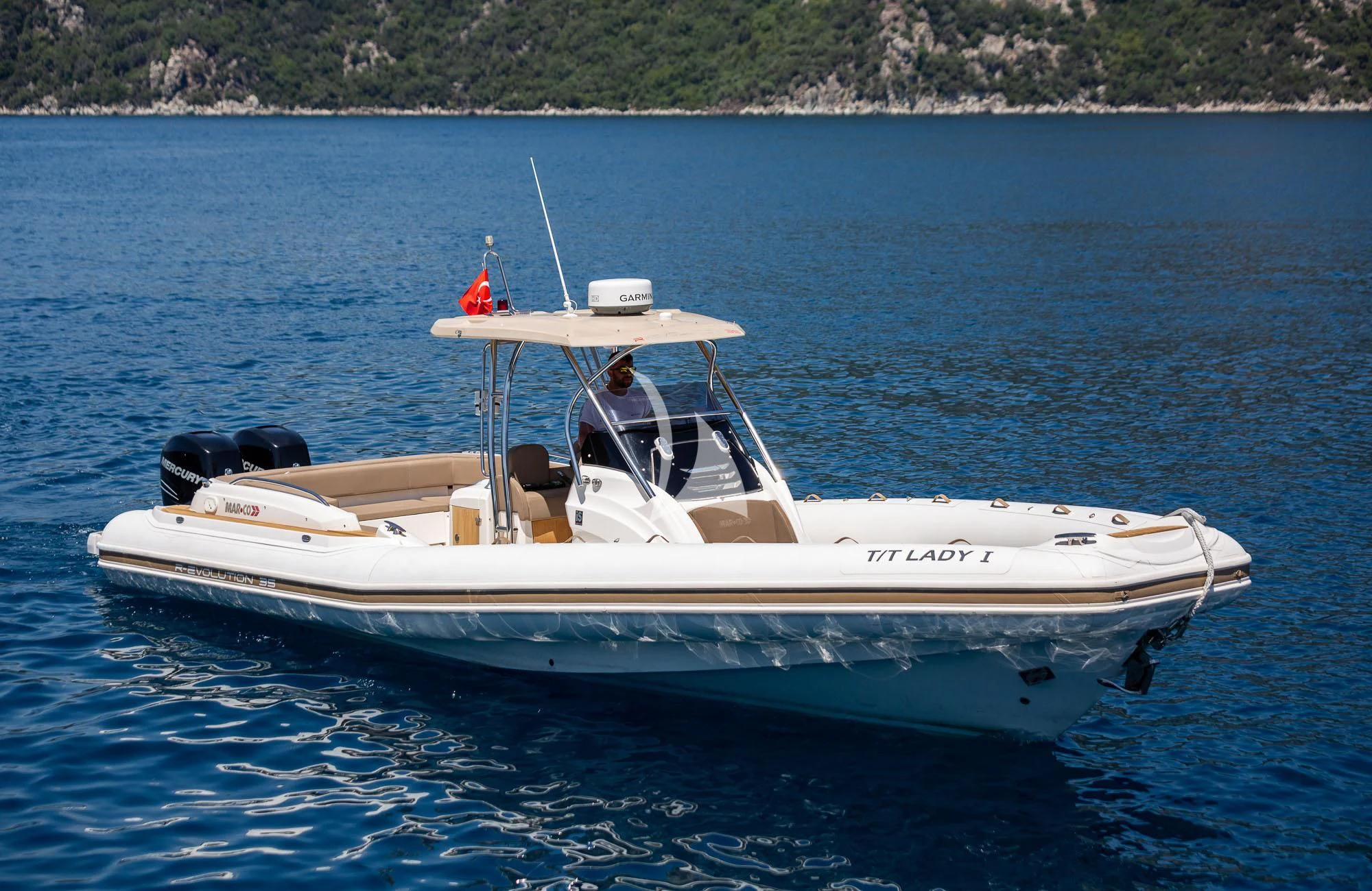 a person driving a boat aboard LADY I Yacht for Charter