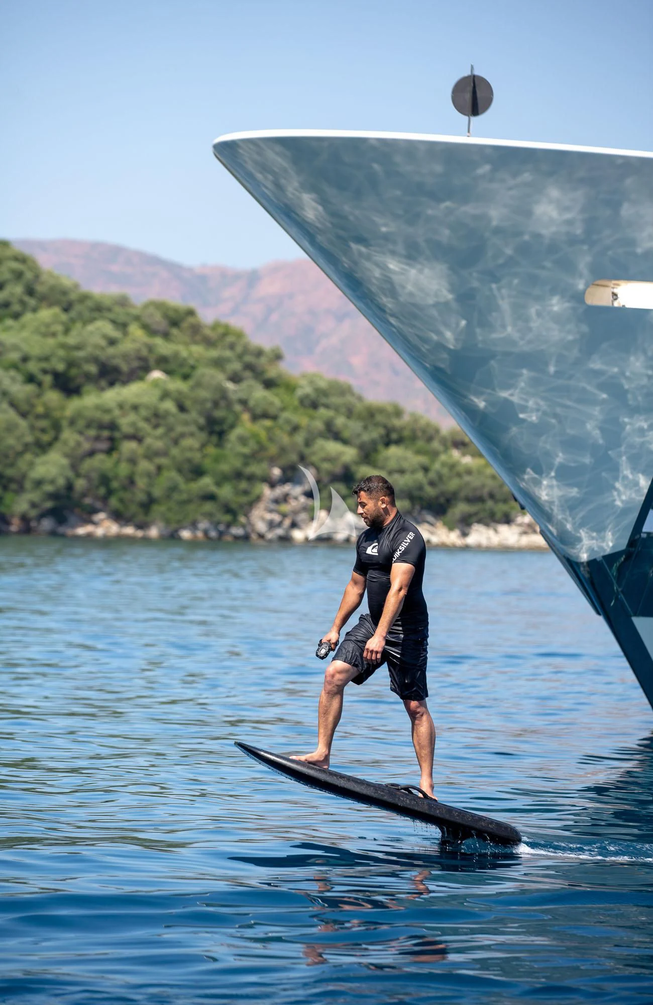 a man on a surfboard in the water aboard LADY I Yacht for Charter