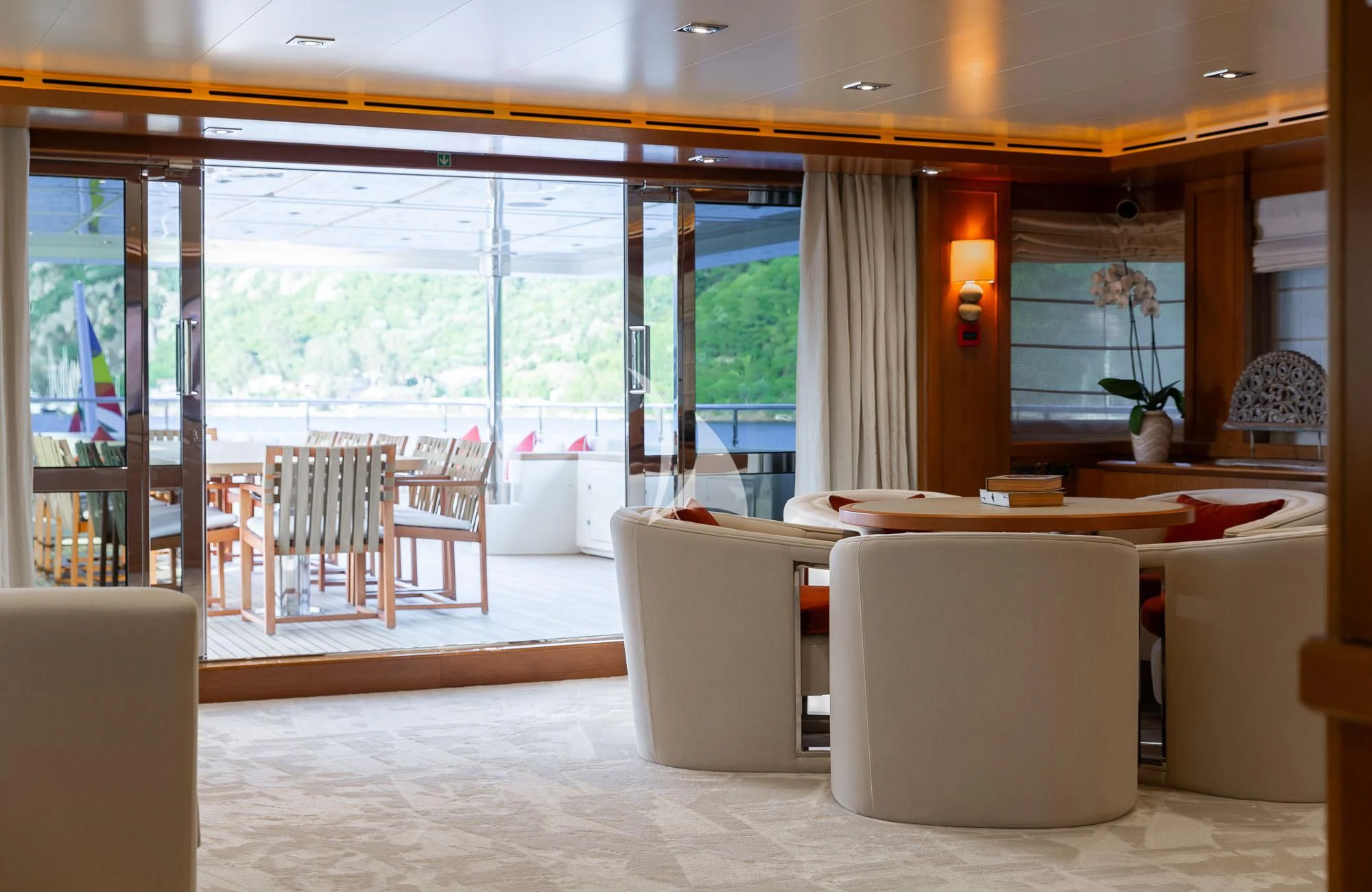 a room with a table chairs and a large window aboard LADY I Yacht for Charter