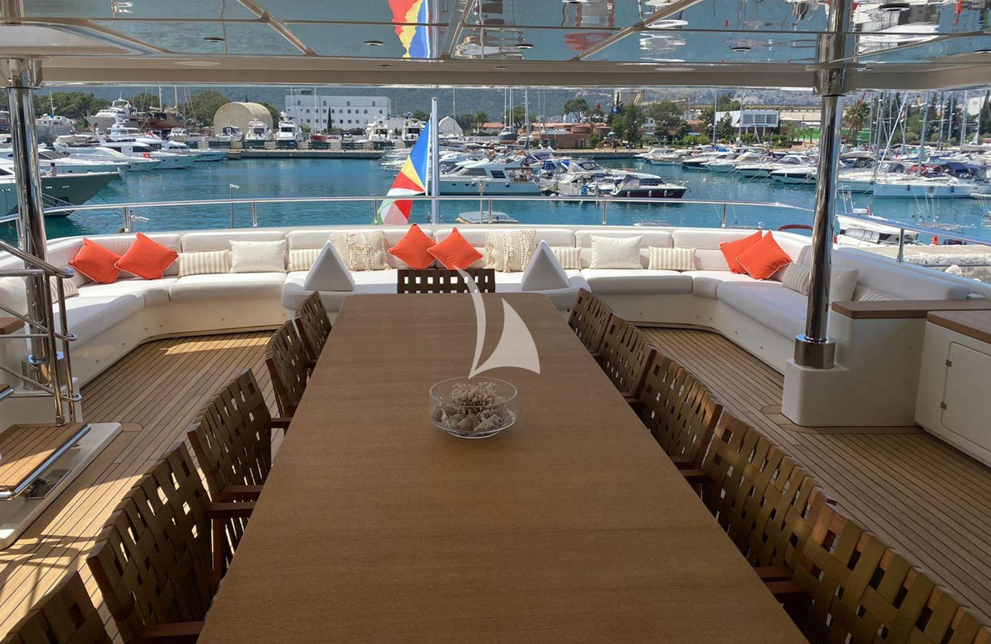 a deck with a table and chairs aboard LADY I Yacht for Charter