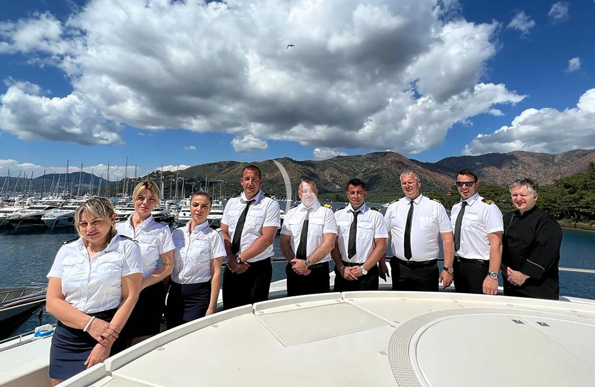 a group of people posing for a photo on a boat aboard LADY I Yacht for Charter