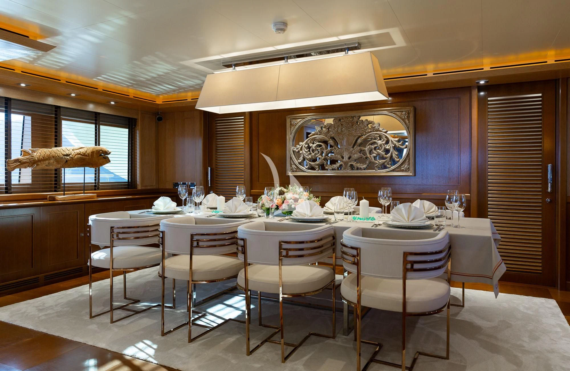 a dining table with white chairs aboard LADY I Yacht for Charter