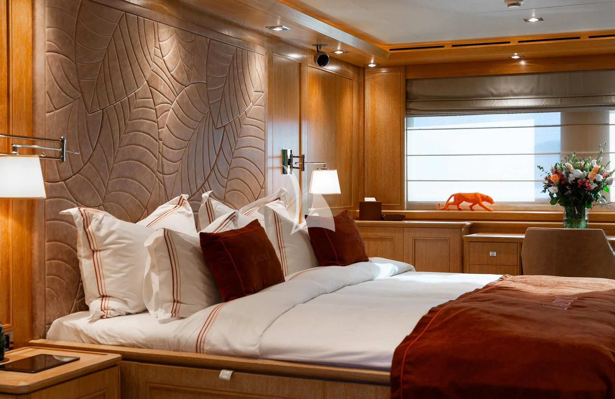a hotel room with a bed and a desk aboard LADY I Yacht for Charter