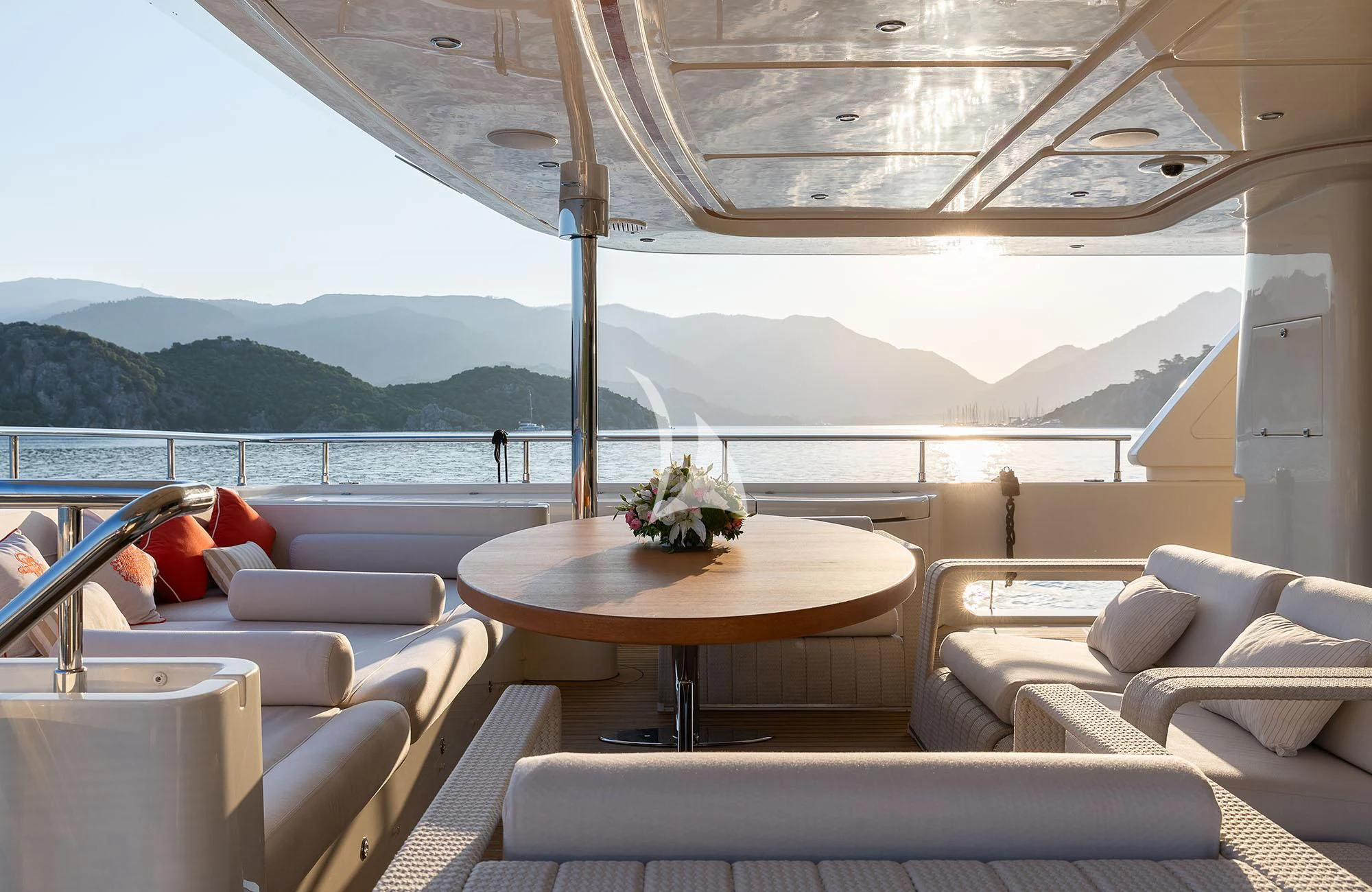 a room with couches and a table with a flower on it aboard LADY I Yacht for Charter