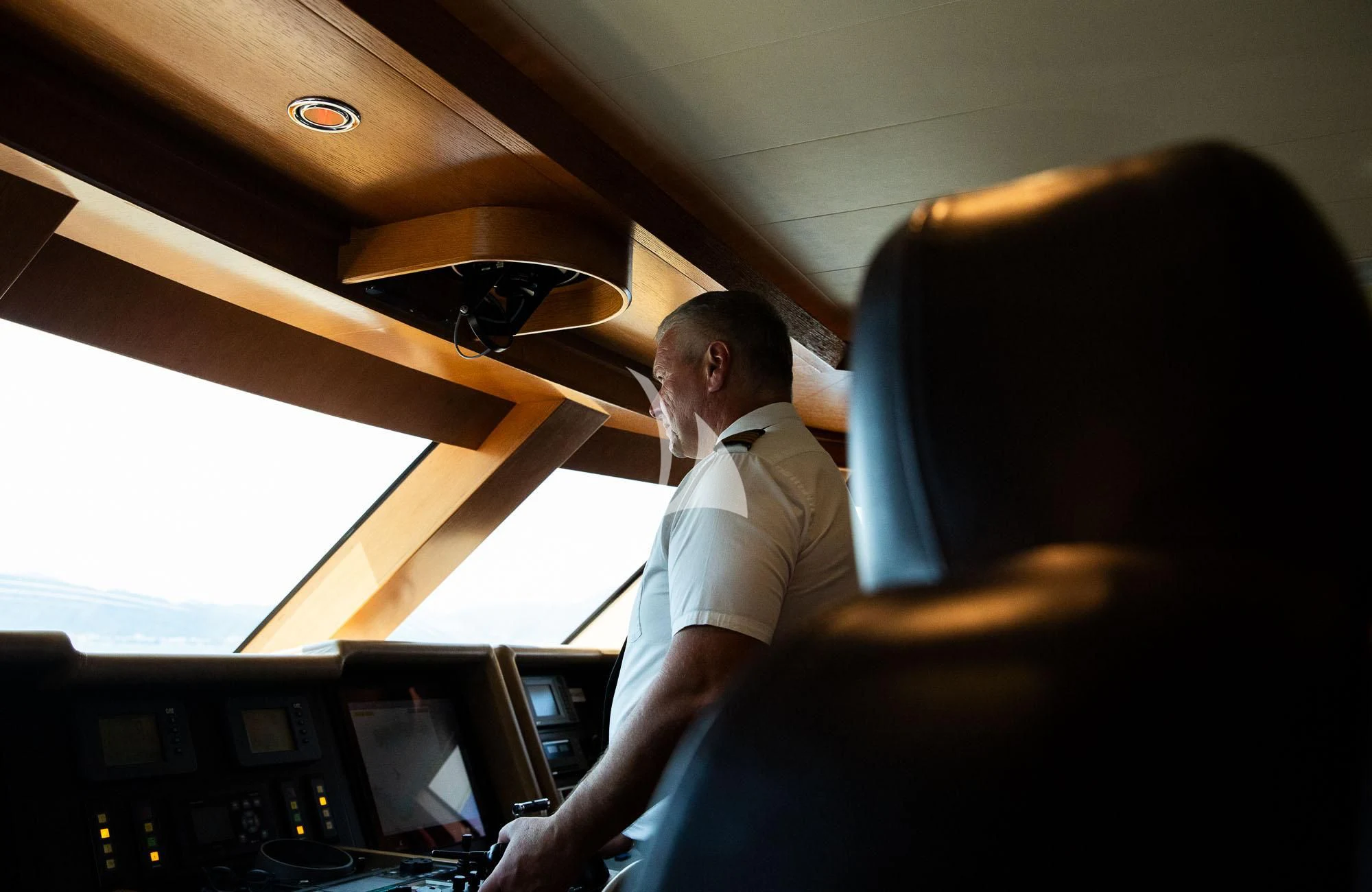 a man sitting in a chair aboard LADY I Yacht for Charter