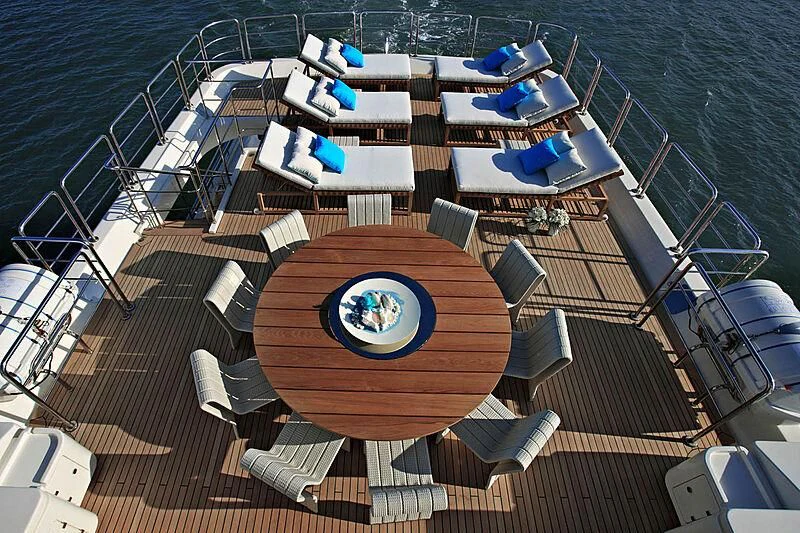 a deck with a pool and lounge chairs on it aboard LADY I Yacht for Charter