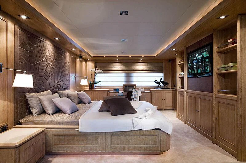 a bedroom with a bed and a tv aboard LADY I Yacht for Charter