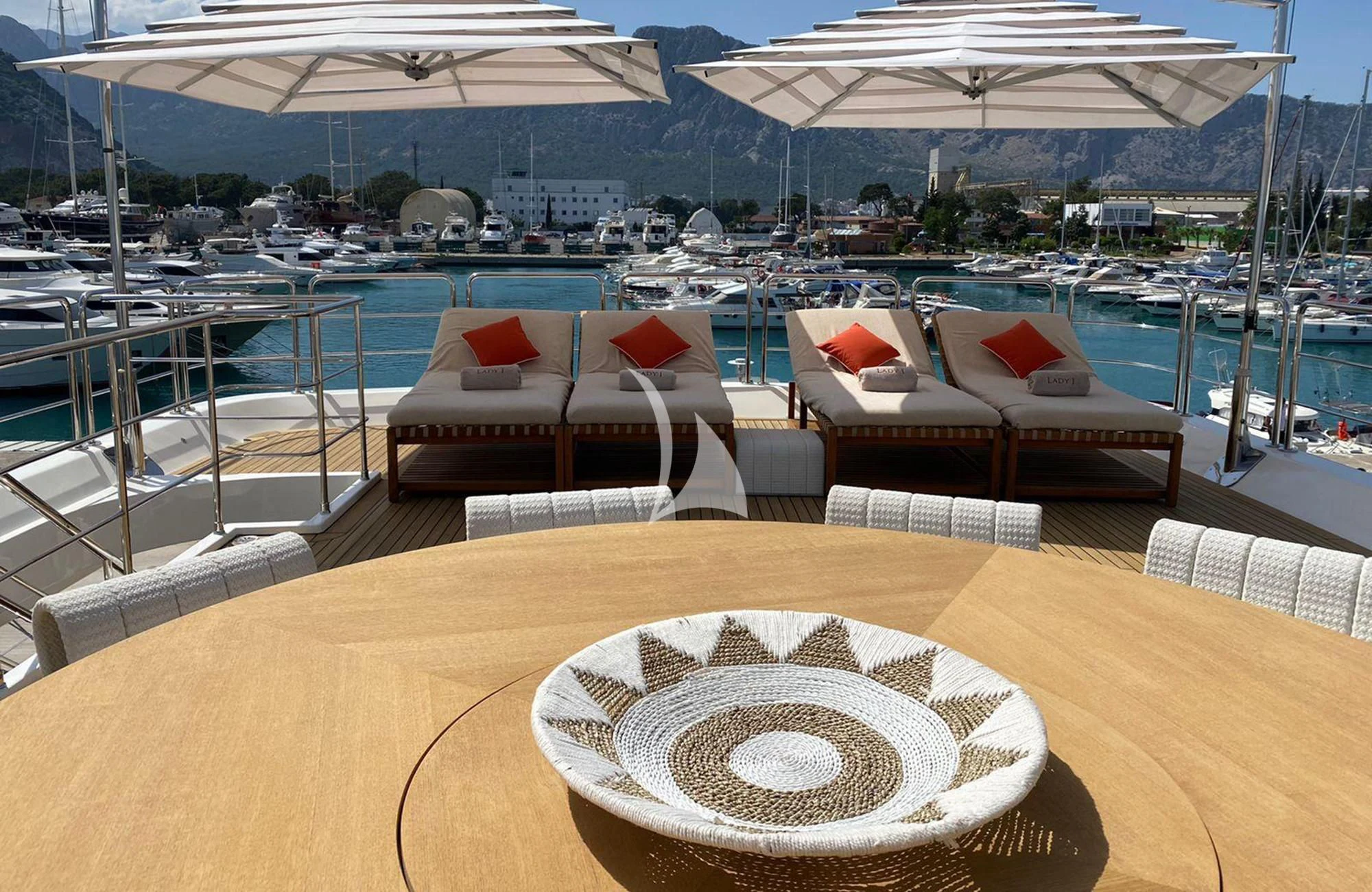 a table with chairs and a plate on it aboard LADY I Yacht for Charter