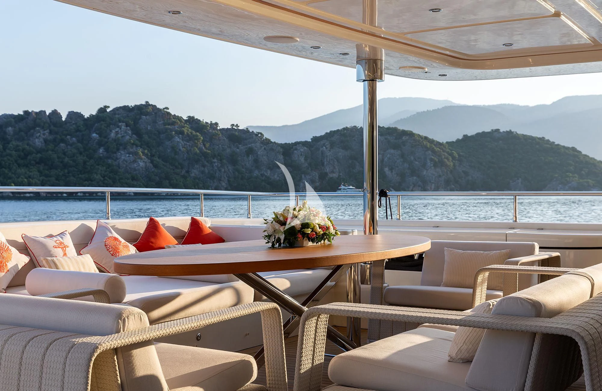 a table with chairs and a view of a body of water aboard LADY I Yacht for Charter