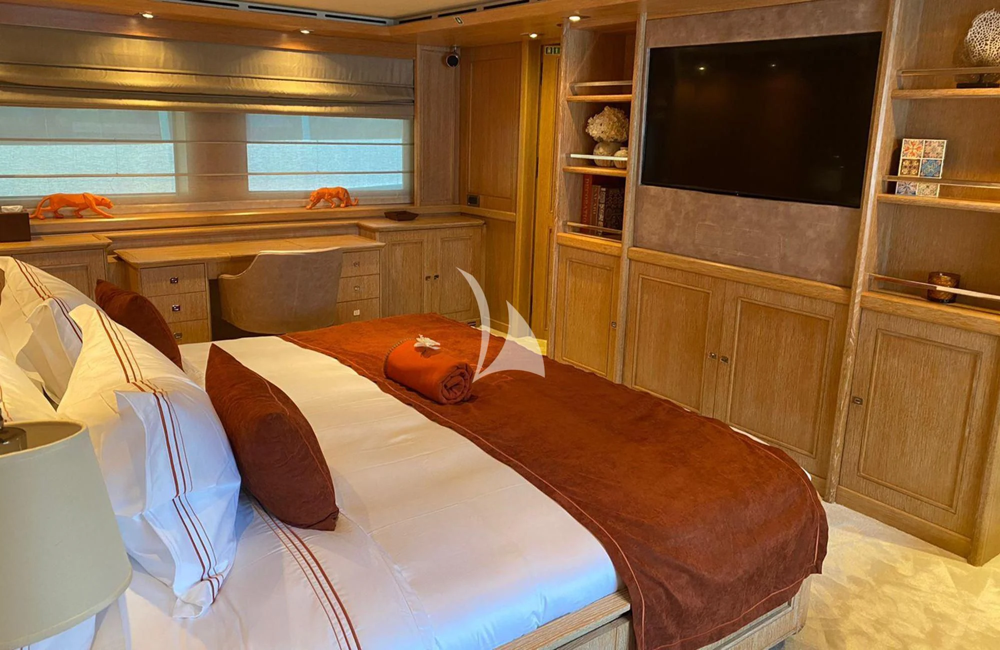 a bedroom with a bed and a television aboard LADY I Yacht for Charter