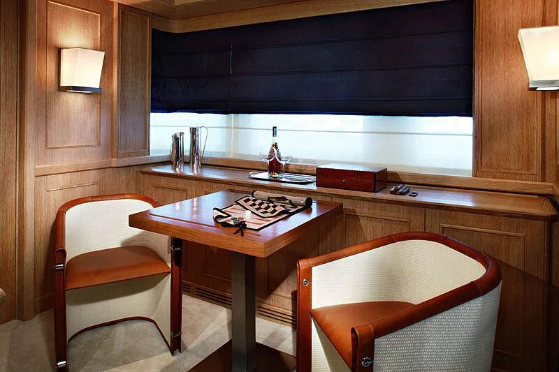 a table with chairs and a bar aboard LADY I Yacht for Charter