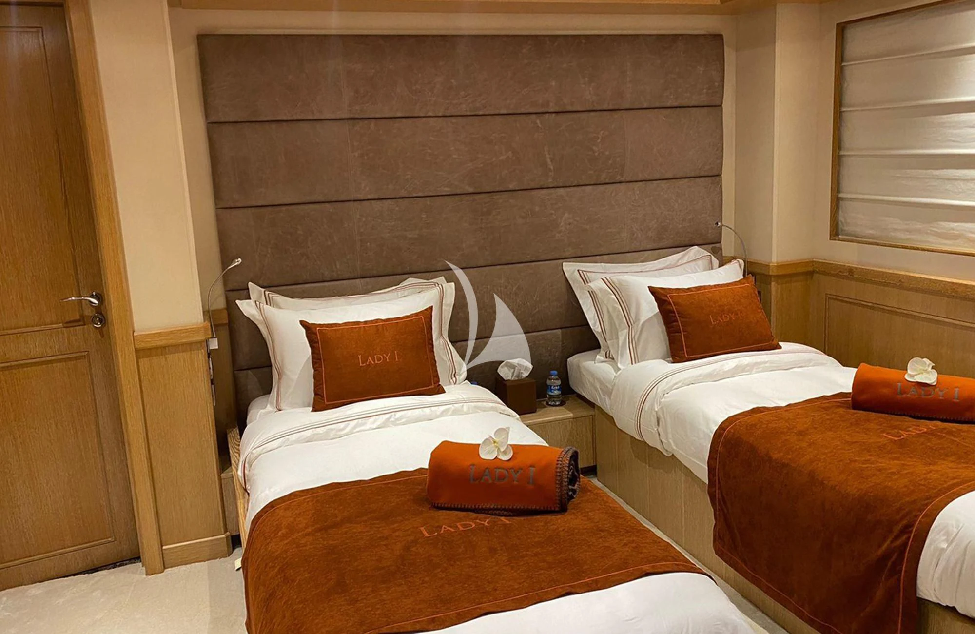 a room with a bed and a wood headboard aboard LADY I Yacht for Charter