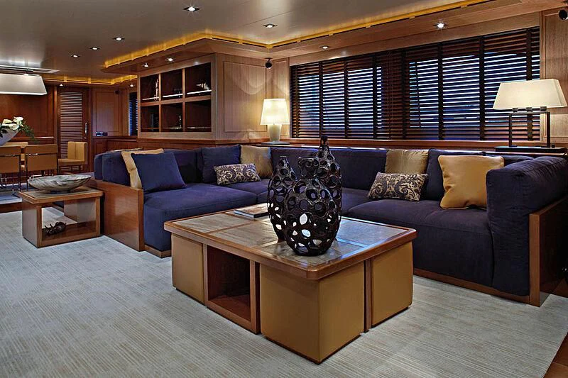 a living room with a blue couch aboard LADY I Yacht for Charter