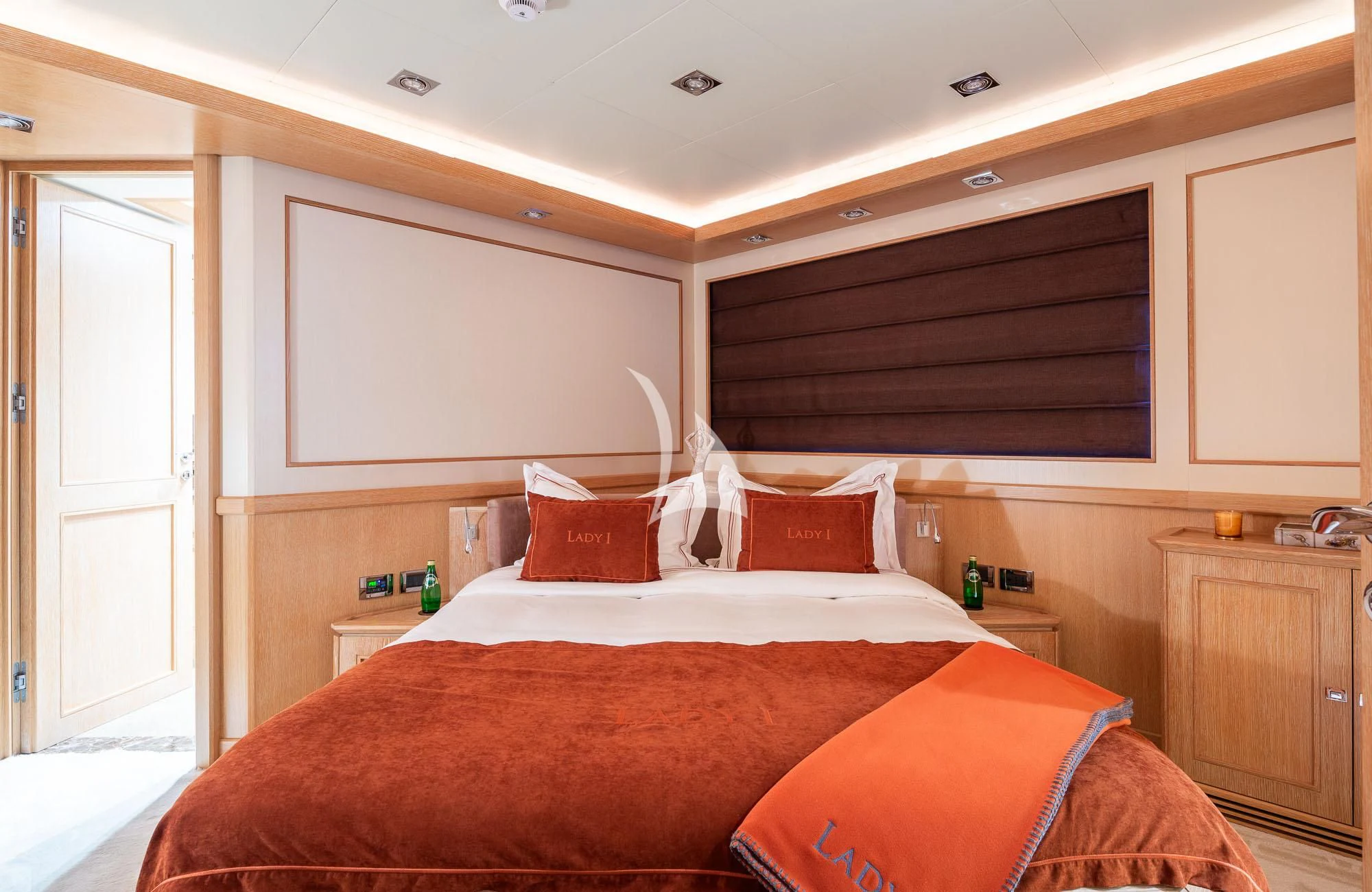 a bedroom with a bed and a dresser aboard LADY I Yacht for Charter