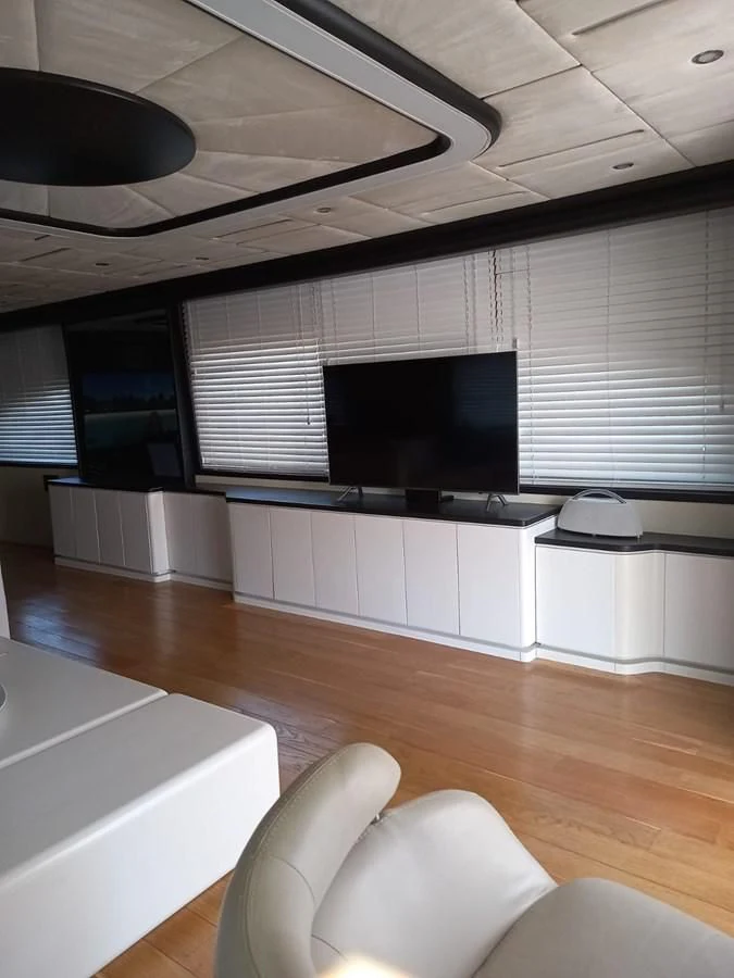 a room with a tv and a couch aboard AKSER Yacht for Sale