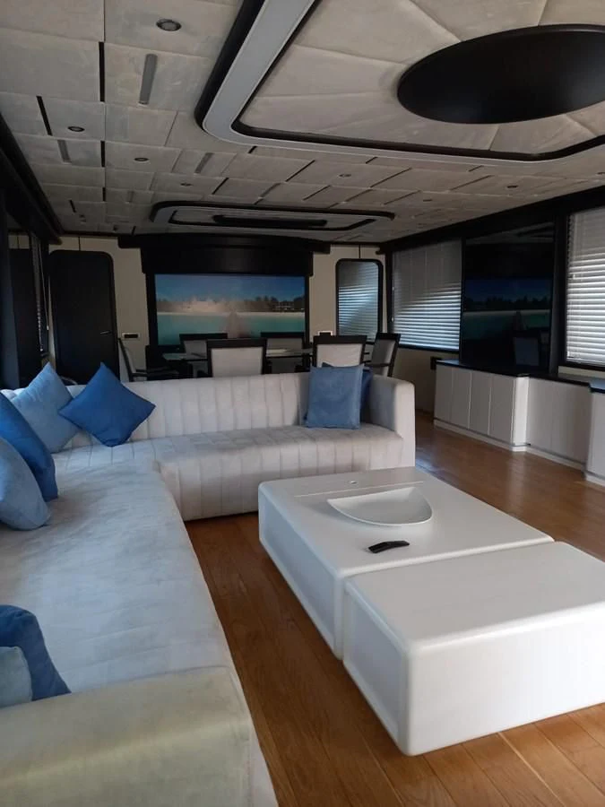 a room with a couch and a table aboard AKSER Yacht for Sale