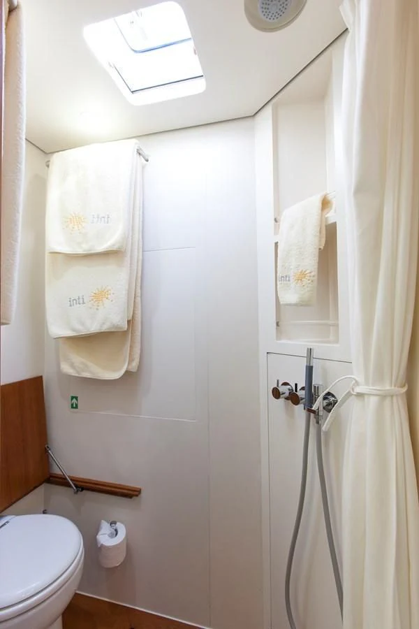 a bathroom with a toilet and a shower aboard INTI CUBE Yacht for Sale