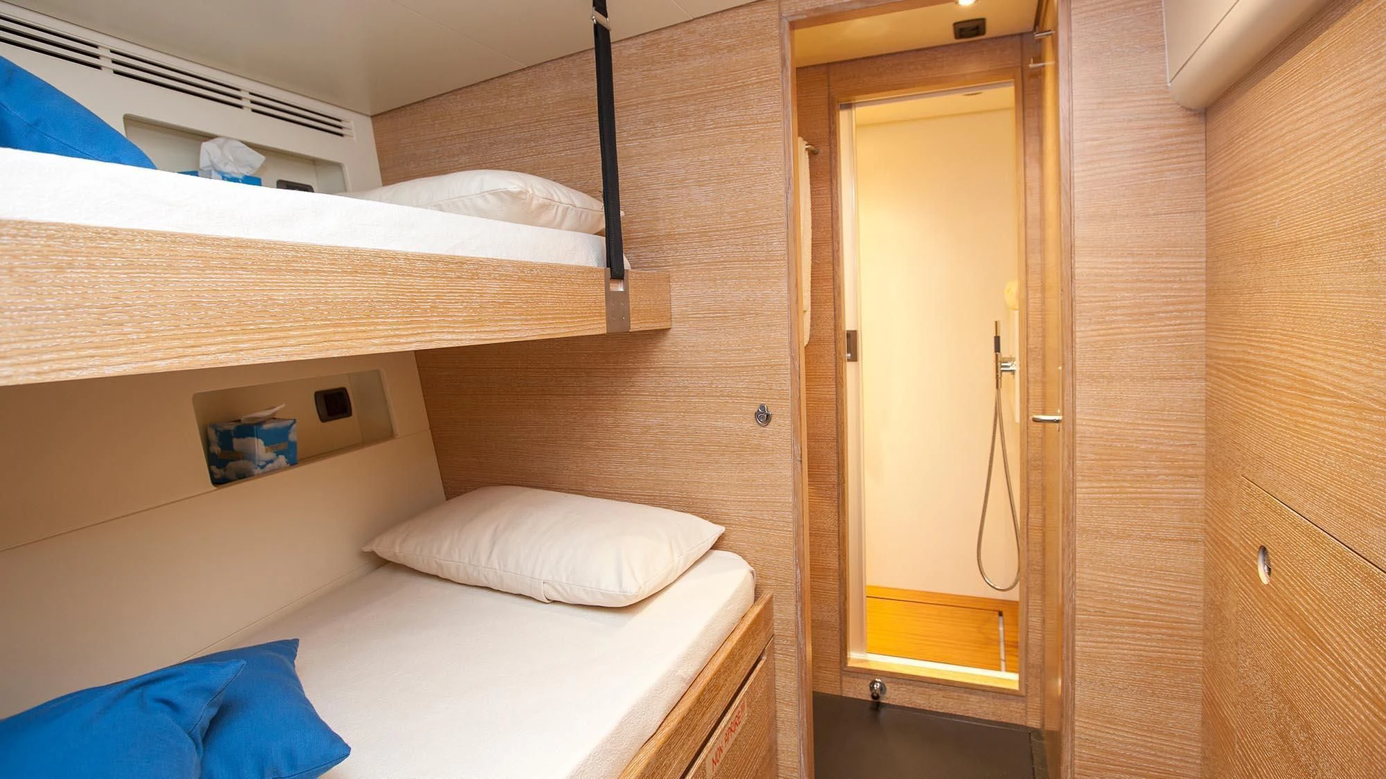 a room with a bed and a closet aboard INTI CUBE Yacht for Sale