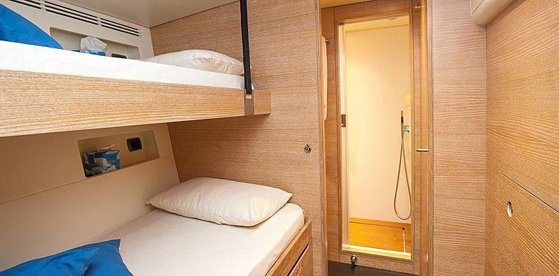 a room with a bed and a closet aboard INTI CUBE Yacht for Sale
