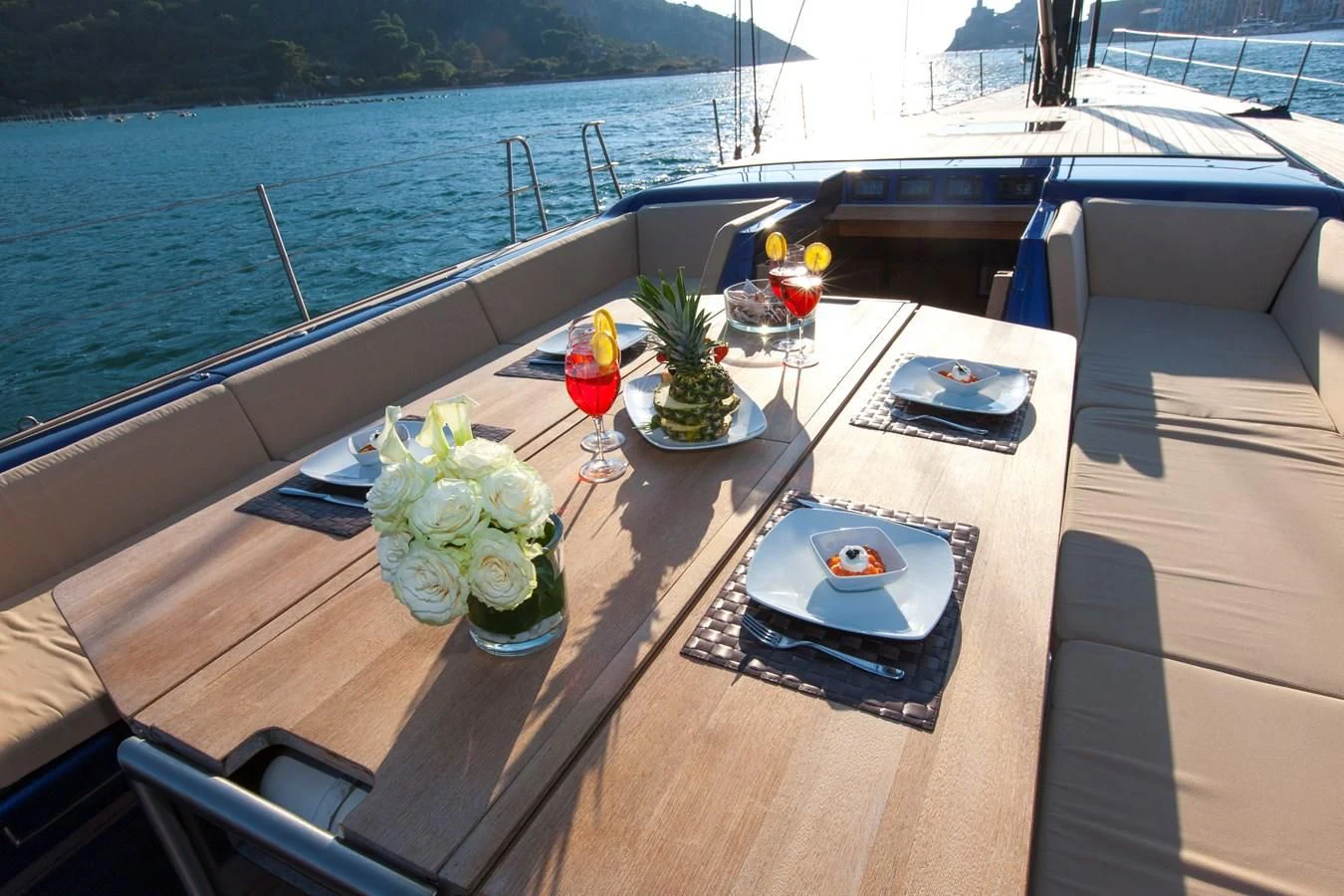 a table with a drink and a tray with flowers on it aboard INTI CUBE Yacht for Sale