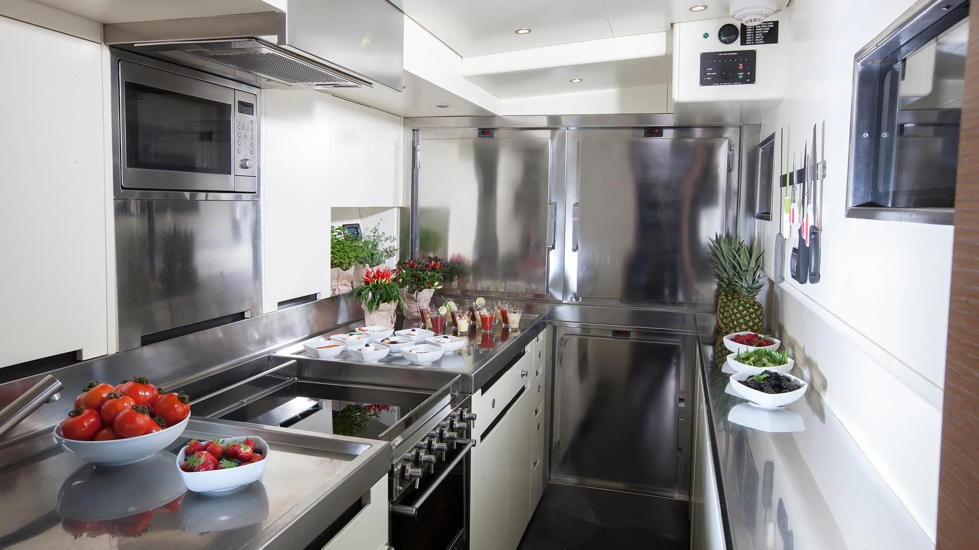 a kitchen with a stainless steel refrigerator aboard INTI CUBE Yacht for Sale