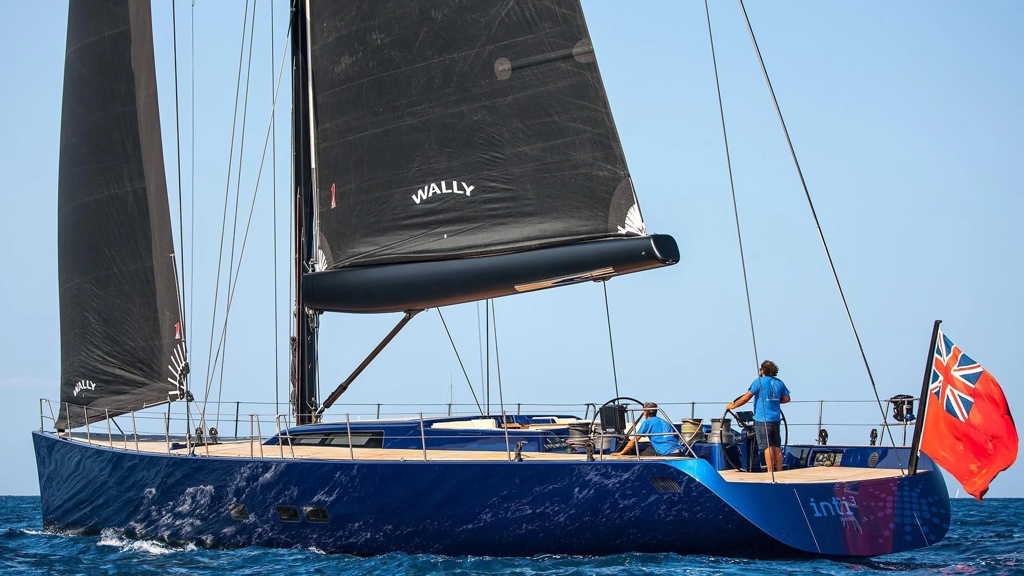 a boat with a flag on the front aboard INTI CUBE Yacht for Sale