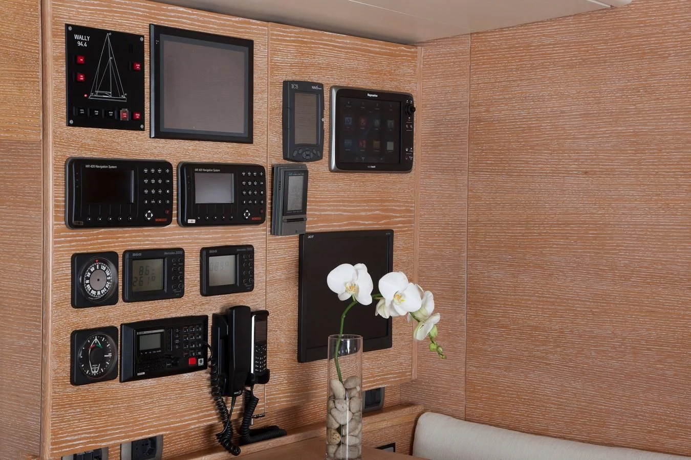 a wall with many devices and a vase with flowers aboard INTI CUBE Yacht for Sale