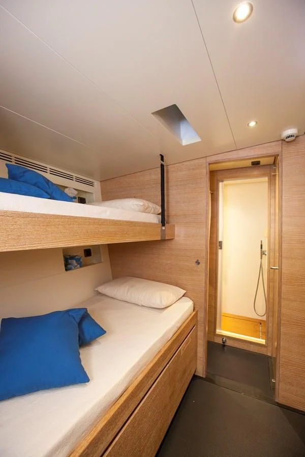 a room with two beds aboard INTI CUBE Yacht for Sale
