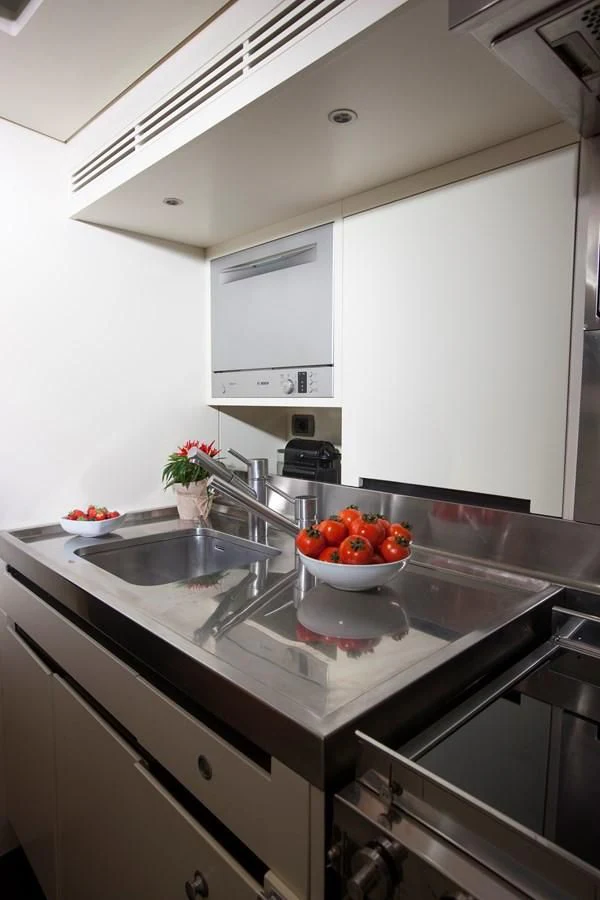 a kitchen with a sink and a bowl of tomatoes aboard INTI CUBE Yacht for Sale