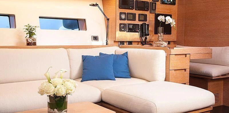 a white couch with blue pillows aboard INTI CUBE Yacht for Sale