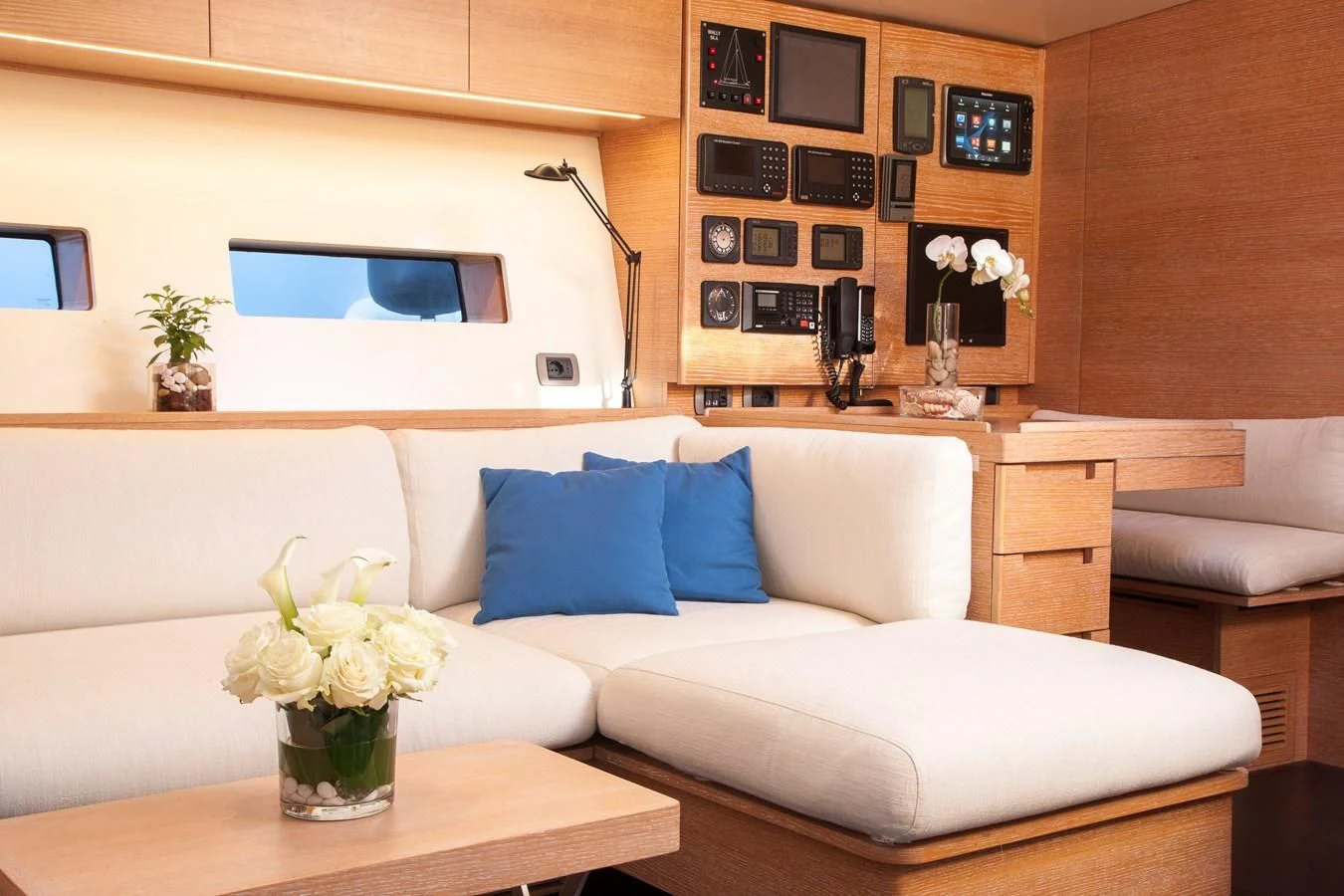 a living room with a white couch and a vase of flowers aboard INTI CUBE Yacht for Sale