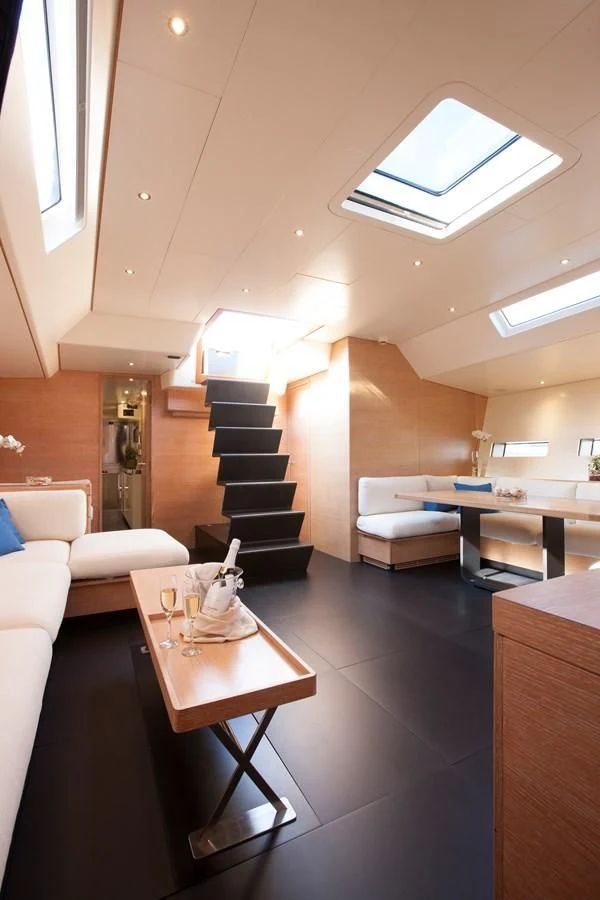 a living room with a staircase aboard INTI CUBE Yacht for Sale