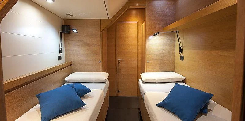 a room with a bed and a closet aboard INTI CUBE Yacht for Sale