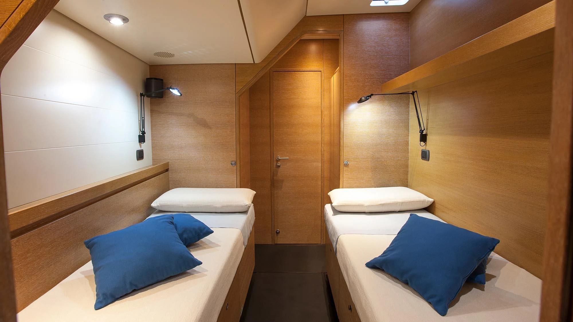 a room with a bed and a wood door aboard INTI CUBE Yacht for Sale