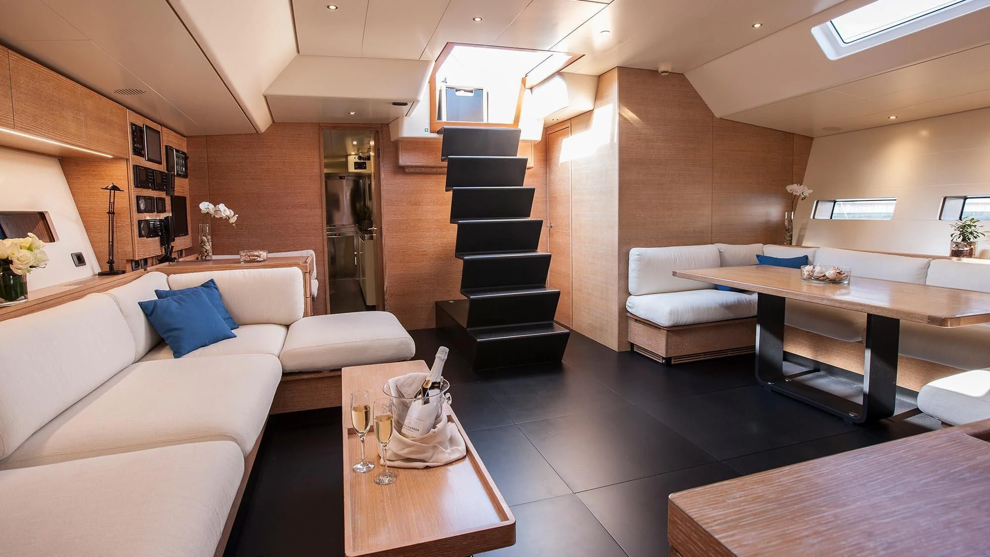 a living room with a staircase aboard INTI CUBE Yacht for Sale