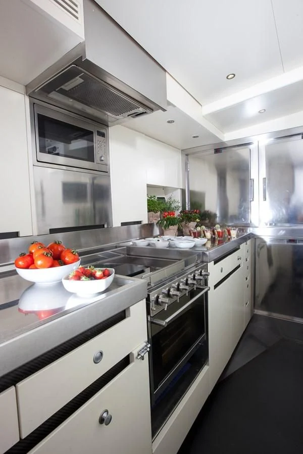 a kitchen with a bowl of fruit aboard INTI CUBE Yacht for Sale