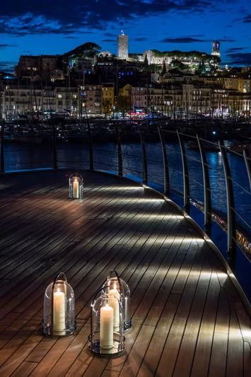a deck overlooking a city at night aboard ATLANTE Yacht for Sale