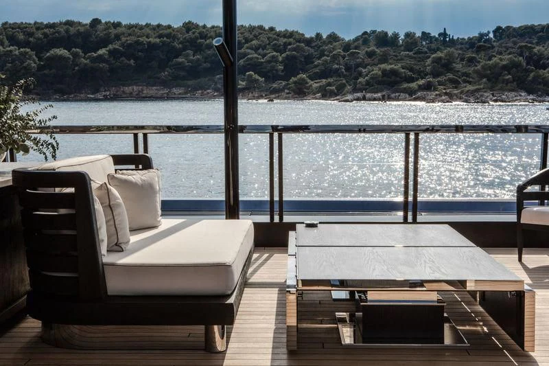 a couple of couches on a deck overlooking a body of water aboard ATLANTE Yacht for Sale