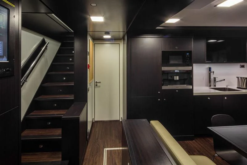 a kitchen with black cabinets aboard ATLANTE Yacht for Sale