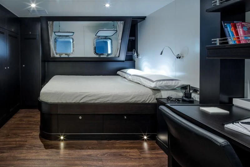 a bedroom with a bed and desk aboard ATLANTE Yacht for Sale