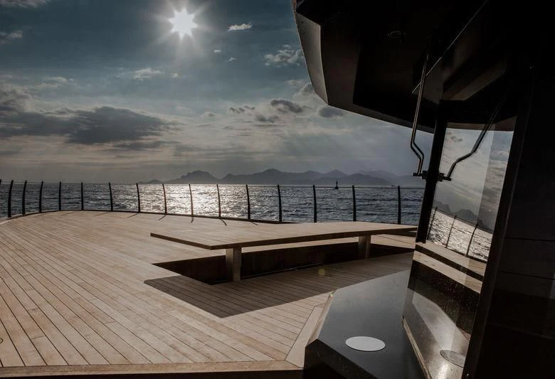 a deck with a view of the ocean and the sun aboard ATLANTE Yacht for Sale