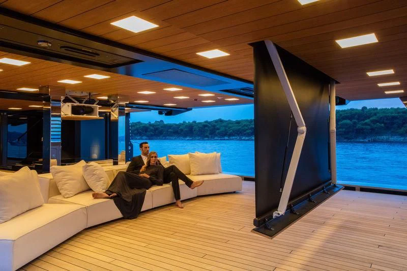 a person sitting on a couch aboard ATLANTE Yacht for Sale