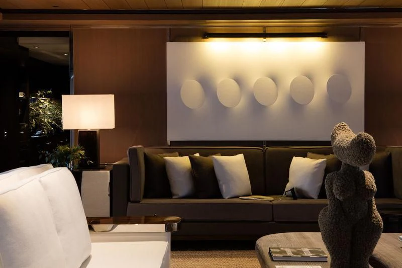 a living room with a large teddy bear on the couch aboard ATLANTE Yacht for Sale