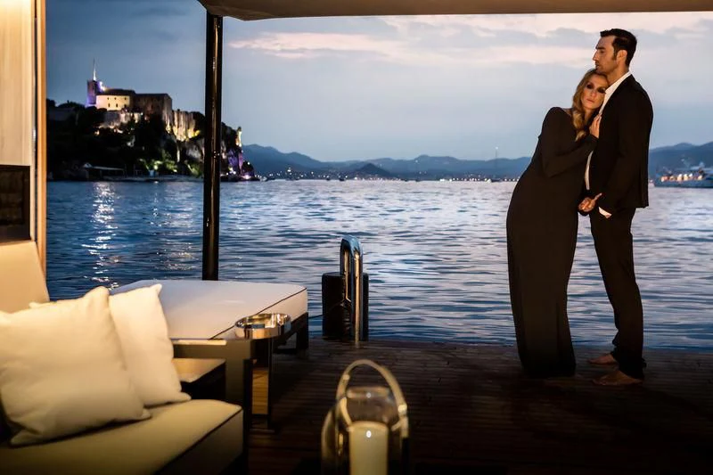a man and woman standing next to each other by a body of water aboard ATLANTE Yacht for Sale