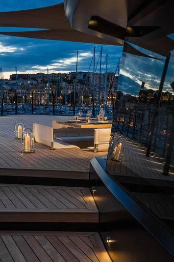 a deck with a view of a city and water aboard ATLANTE Yacht for Sale