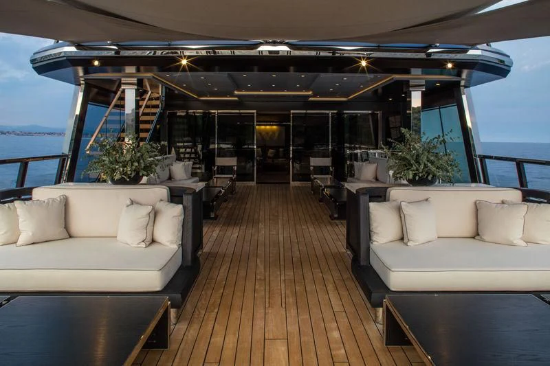 a large living room with a wood floor and white couches aboard ATLANTE Yacht for Sale