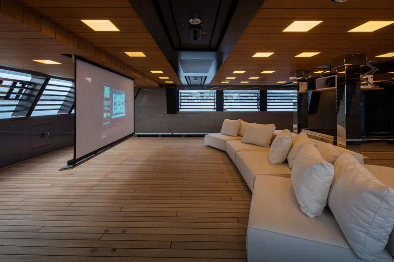 a room with a couch and a television on the wall aboard ATLANTE Yacht for Sale