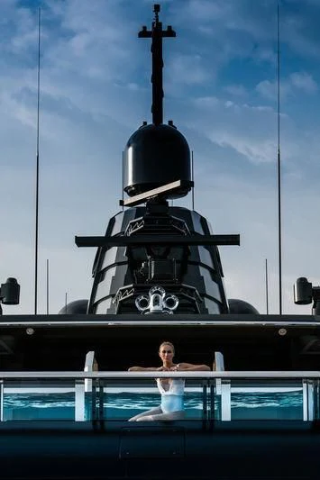 a person standing in front of a large ship aboard ATLANTE Yacht for Sale
