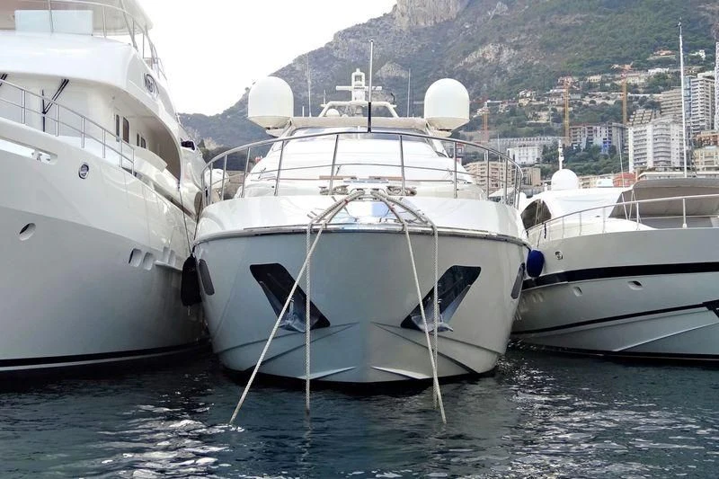 several white boats in a harbor aboard RAHIL Yacht for Sale